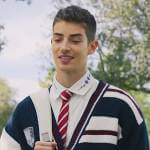 Patric’s white print collar shirt and varsity cardigan on Elite