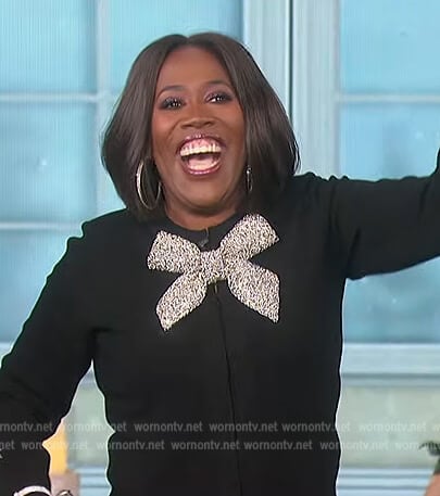 Sheryl's black bow embellished cardigan on The Talk