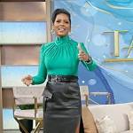 Tamron’s green turtleneck top and leather skirt on Tamron Hall Show