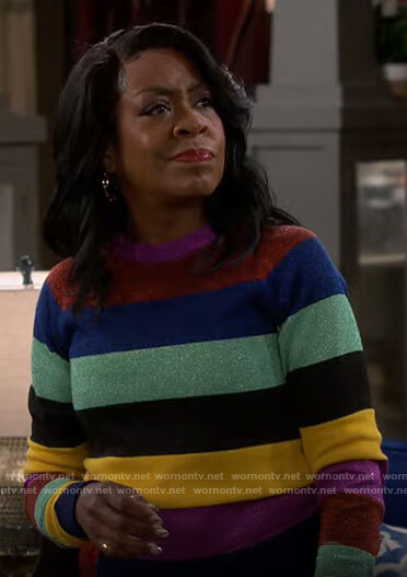Tina’s multi colored striped sweater on The Neighborhood