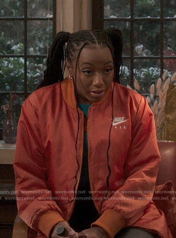Whitney's long orange Nike bomber jacket on The Sex Lives of College Girls