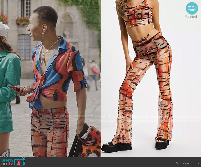 Bershka Exposed seam patterened flare pants with thong detail in orange worn by Etienne (Jin Xuan Mao) on Emily in Paris