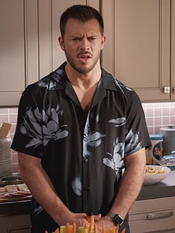 Connor's black floral print shirt on Home Economics