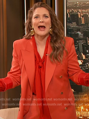 Drew's orange blazer and tie neck blouse on The Drew Barrymore Show