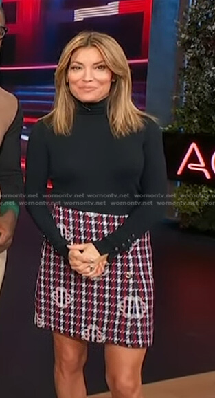 Kit’s black sweater and plaid mini skirt on Access Hollywood