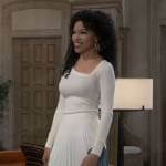 Portia’s white asymmetric sweater and colorblock pleated skirt on General Hospital