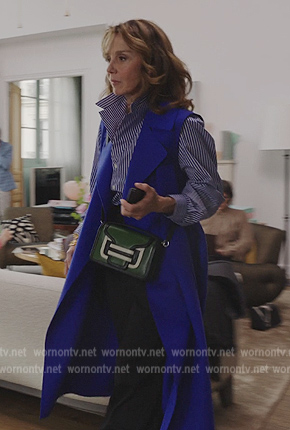 Sylvie's blue sleeveless coat on Emily in Paris