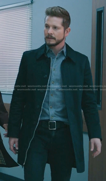 Conrad’s denim shirt and black topcoat on The Resident