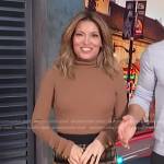 Kit’s brown turtleneck top and plaid skirt on Access Hollywood