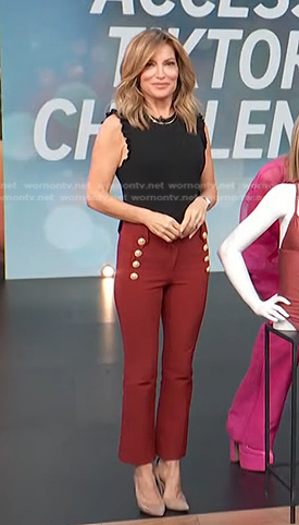 Kit’s black sleeveless knit top and red pants on Access Hollywood