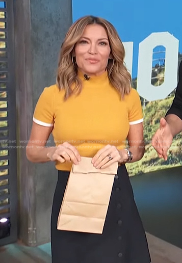 Kit’s yellow top and belted skirt on Access Hollywood