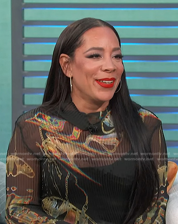 Selenis Leyva’s black printed top and check pants on Access Hollywood