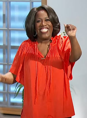 Sheryl’s red pleated tie neck blouse on The Talk