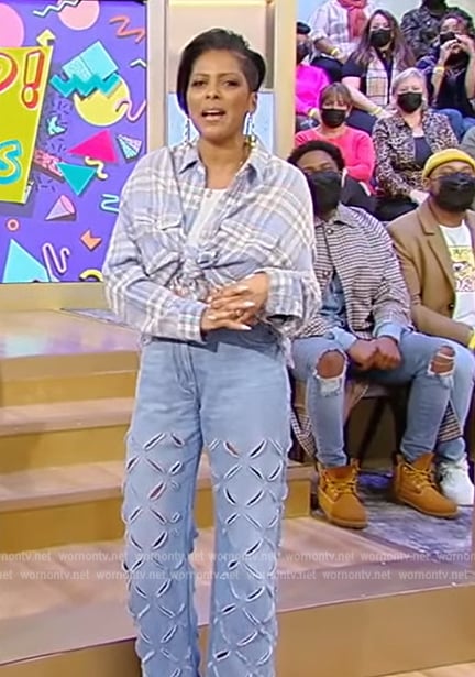 Tamron's blue plaid shirt and eyelet jeans on Tamron Hall Show