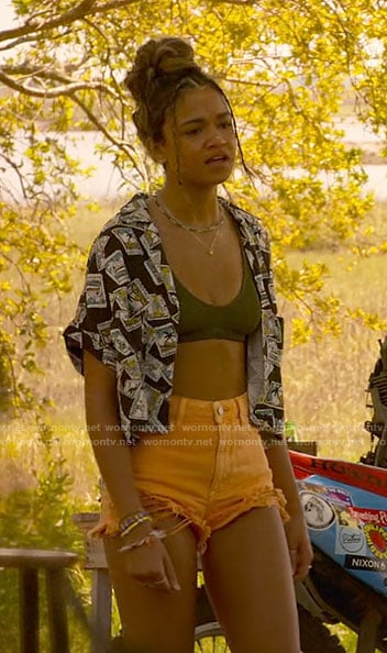 Kiara's stamp print shirt, olive green bikini top, and orange denim shorts on Outer Banks
