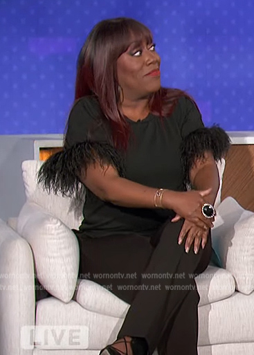 Sheryl’s black feather trim top on The Talk