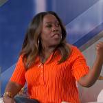 Sheryl’s orange ribbed polo top on The Talk