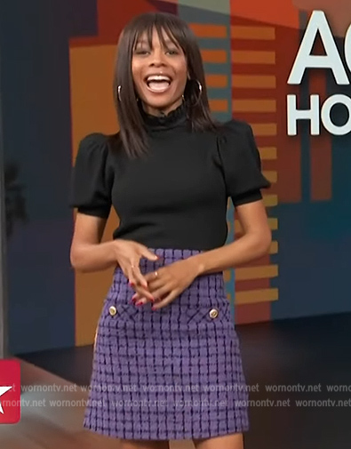 Zuri's purple tweed skirt and black puff sleeve top on Access Hollywood