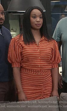 Kristen's orange striped top and skirt on Grand Crew