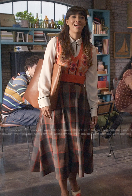 Sam’s printed sweater vest and plaid skirt on Not Dead Yet