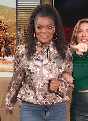 Yvette Nicole Brown’s brown floral tie neck blouse on Access Hollywood