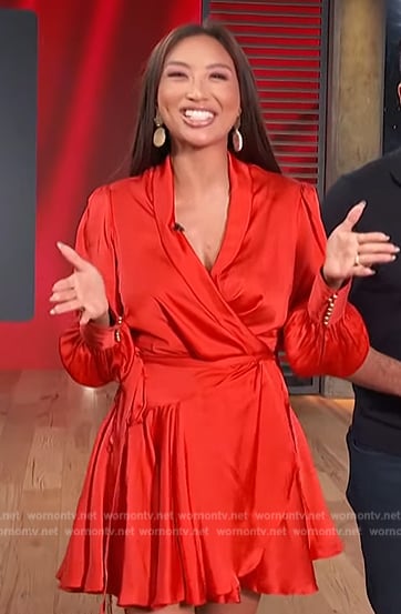 Jeannie Mai’s red satin wrap mini dress on Access Hollywood