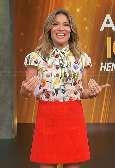 Kit’s floral tie neck top and red mini skirt on Access Hollywood