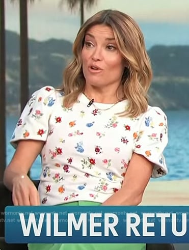 Kit’s white floral print short sleeve top on Access Hollywood