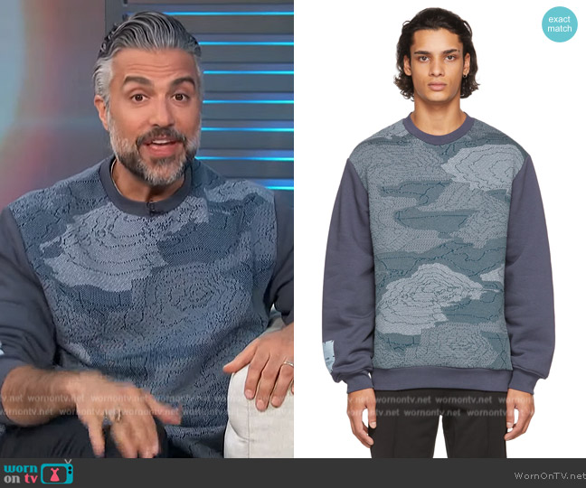 McQ Navy Storm Cloud Relaxed Sweatshirt worn by Jaime Camil on Access Hollywood