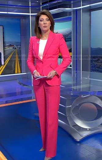 Norah’s fuchsia pink suit on CBS Evening News