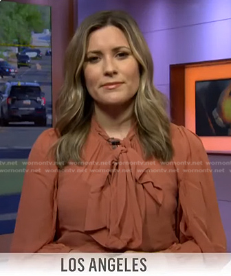 Erin McLaughlin’s orange tie neck blouse on Today