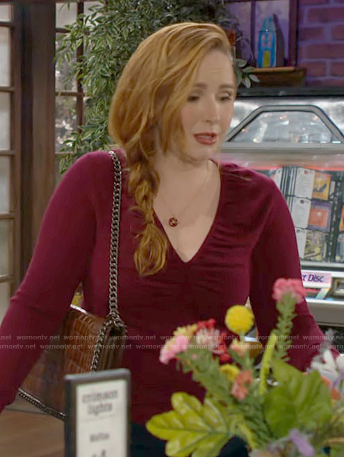 Mariah's red v-neck sweater and brown croc bag on The Young and the Restless