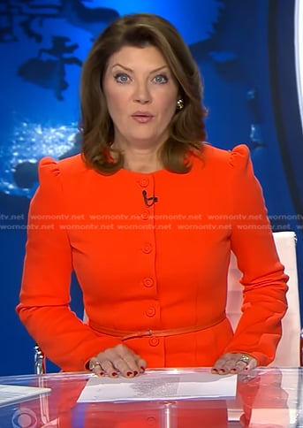 Norah’s orange belted jacket and cropped pants on CBS Evening News