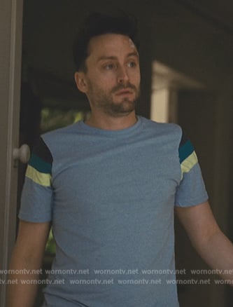 Roman's blue striped tee on Succession