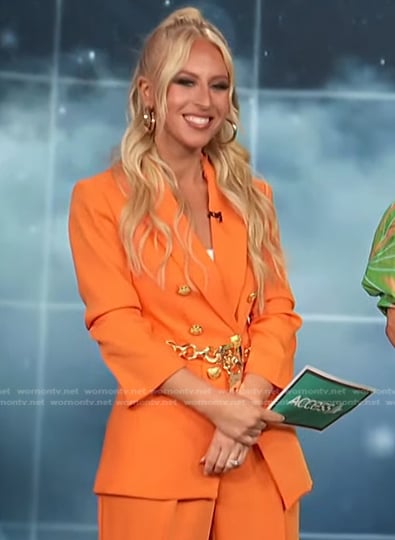 Sydney Sadick’s orange blazer with gold buttons on Access Hollywood