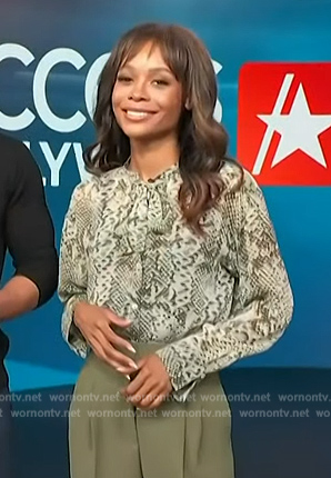 Zuri’s green animal print tie neck blouse on Access Hollywood