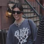 Kourtney’s Blink 182 print tee and heart bag on The Kardashians