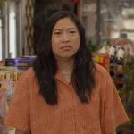 Nora’s orange printed shirt on Awkwafina is Nora From Queens