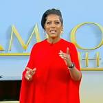 Tamron’s red pleated cape dress on Tamron Hall Show