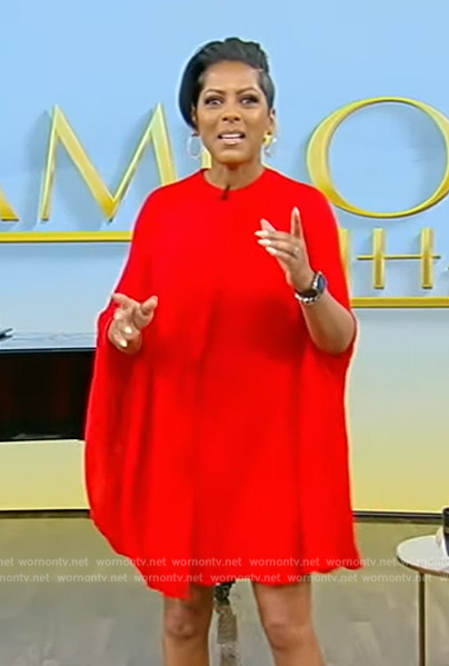 Tamron’s red pleated cape dress on Tamron Hall Show