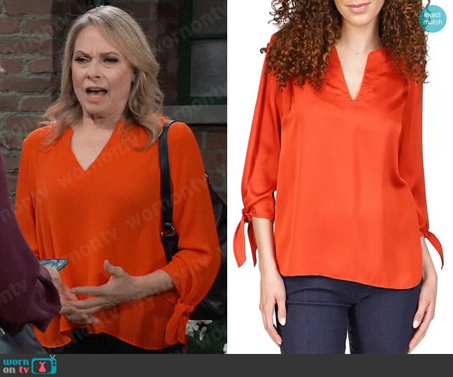 MICHAEL Michael Kors Solid Satin Tie Sleeve Split V-Neck Woven Blouse in Bright Terracotta worn by Gladys Corbin (Bonnie Burroughs) on General Hospital