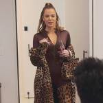 Khloe’s leopard print coat and boots on The Kardashians