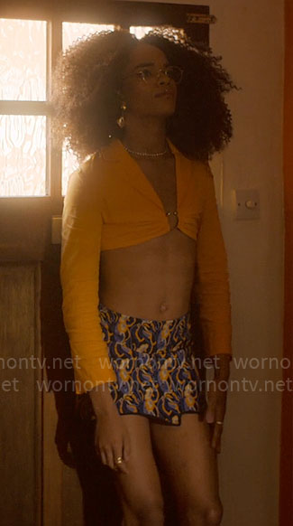 Elle's orange crop top with ring and printed mini skirt on Heartstopper