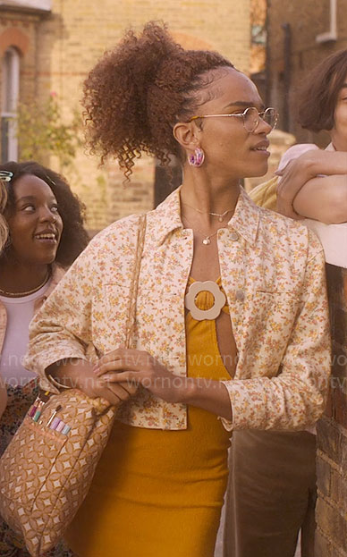 Elle's yellow cutout mini dress with flower buckle and floral denim jacket on Heartstopper