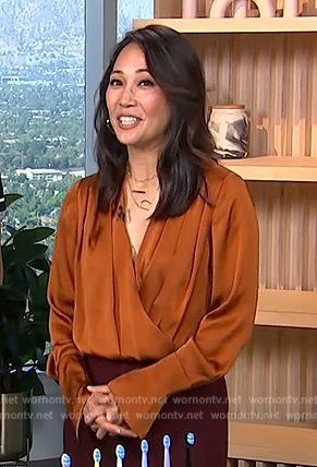 Diane Mizota’s orange wrap bodysuit on Access Hollywood