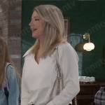 Nina’s white collared blouse and beige and white bag on General Hospital