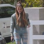 Khloe’s green bomber jacket and distressed jeans on The Kardashians