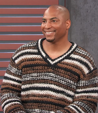 Dorian Renaud’s brown stipe knit sweater on Access Hollywood