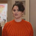 Mabel’s orange knit sweater and patchwork mini skirt on Only Murders in the Building