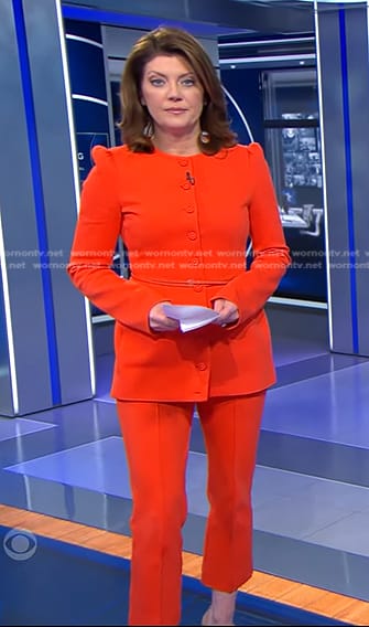 Norah's orange belted jacket and cropped pants on CBS Evening News